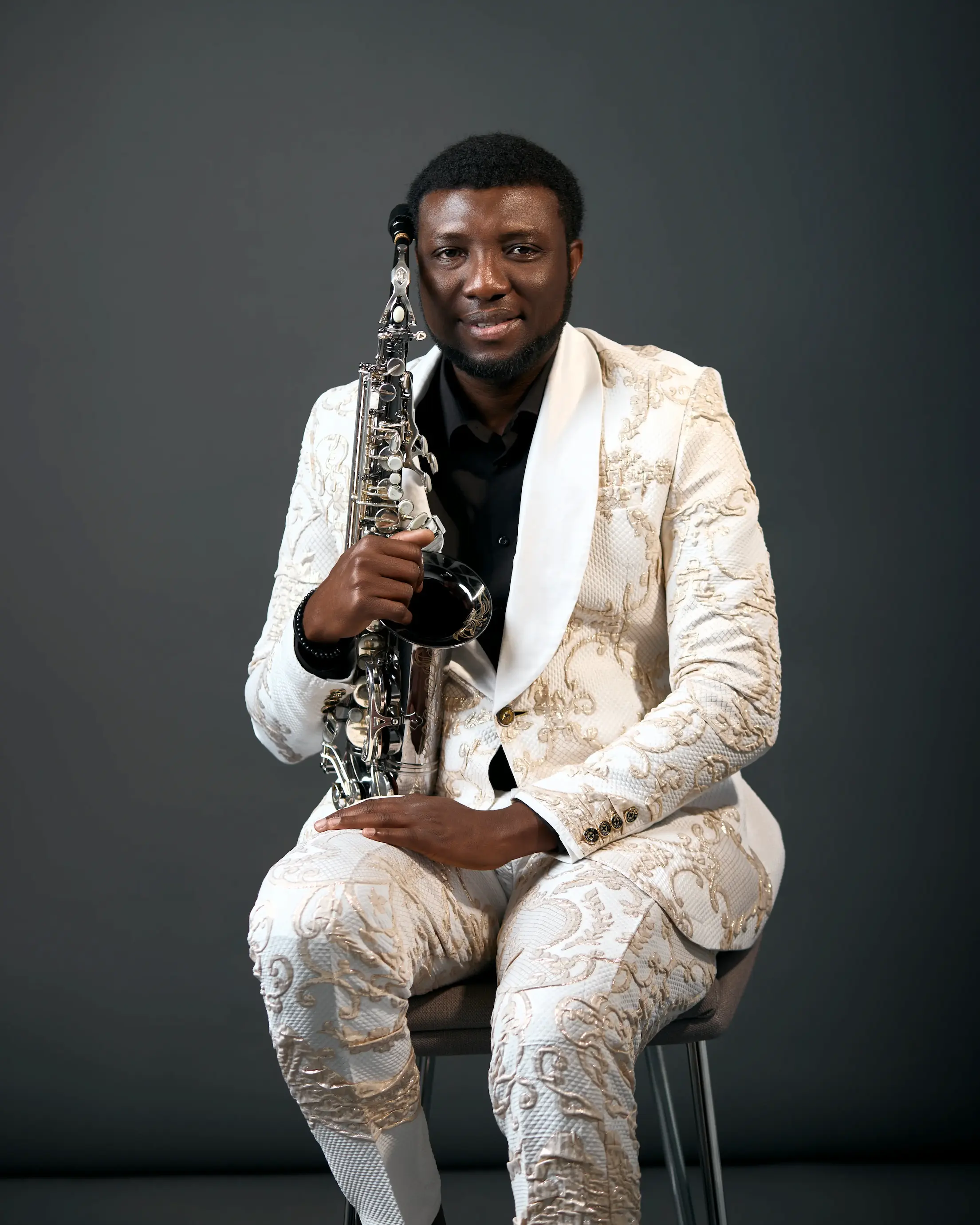 Royal WoleSax holding saxophone